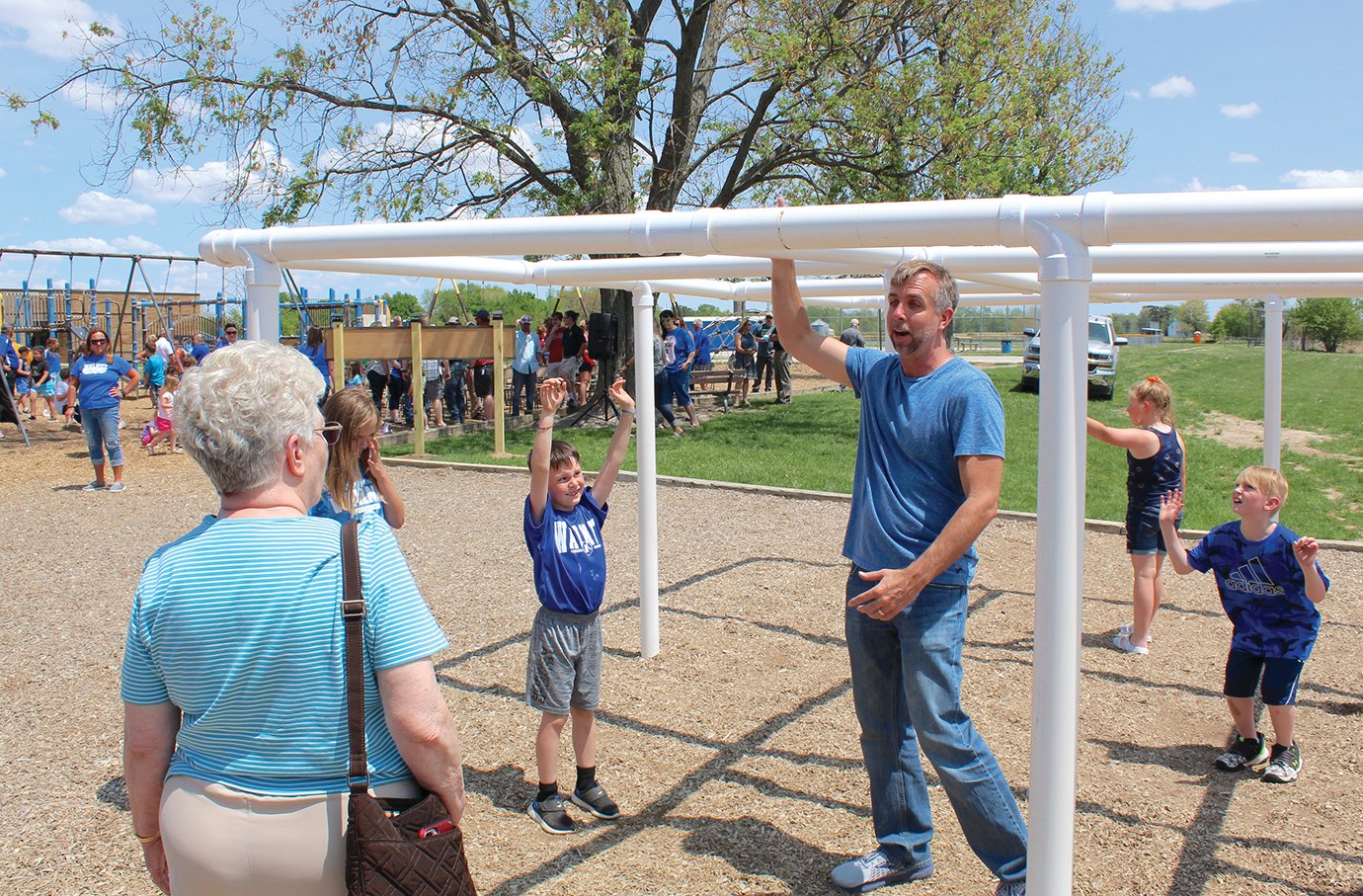 Students, staff, family and friends of the Schroll family immediately began checking out playground equipment recently installed as a playground extension called Parker